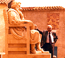 Prof. Grande Covin poses beside the statue of Michael Servetus the day he joined the Michael Servetus Institute.